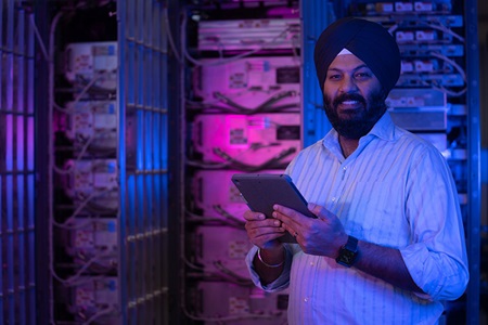 man standing in front of electronic racks