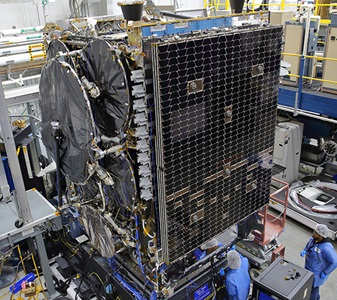 two technicians working on satellite in highbay