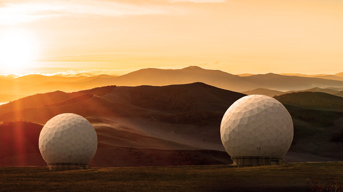 Two Relay Ground Stations with mountains in background