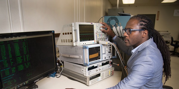 Metrology Services – Services and Capabilities Black man working on metrology calibration devices