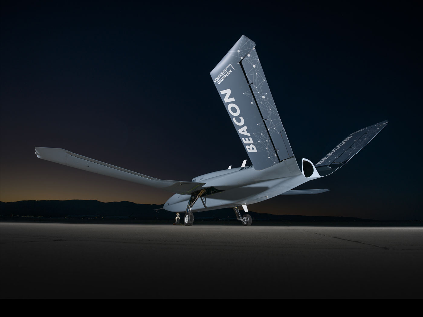 Beacon Aircraft at night in front of mountains