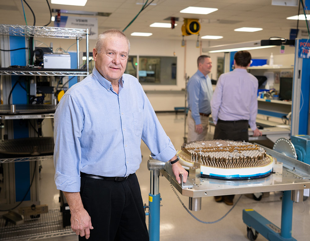 AN/APG-81 Active Electronically Scanned Array (AESA) employee standing next to active electronically scanned array radar in lab