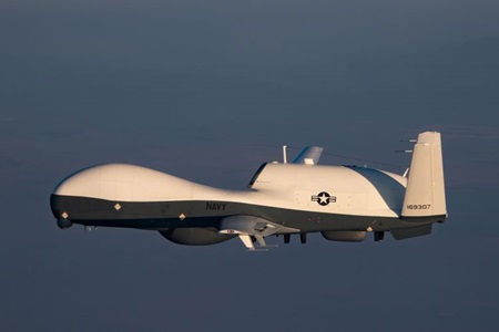 MQ-4C Triton Achieves Initial Operating Capability with the US Navy aircraft flying over an ocean