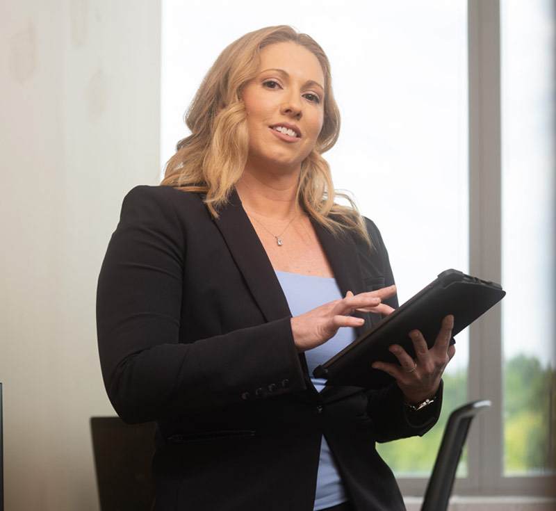 woman wearing business suit holding tablet