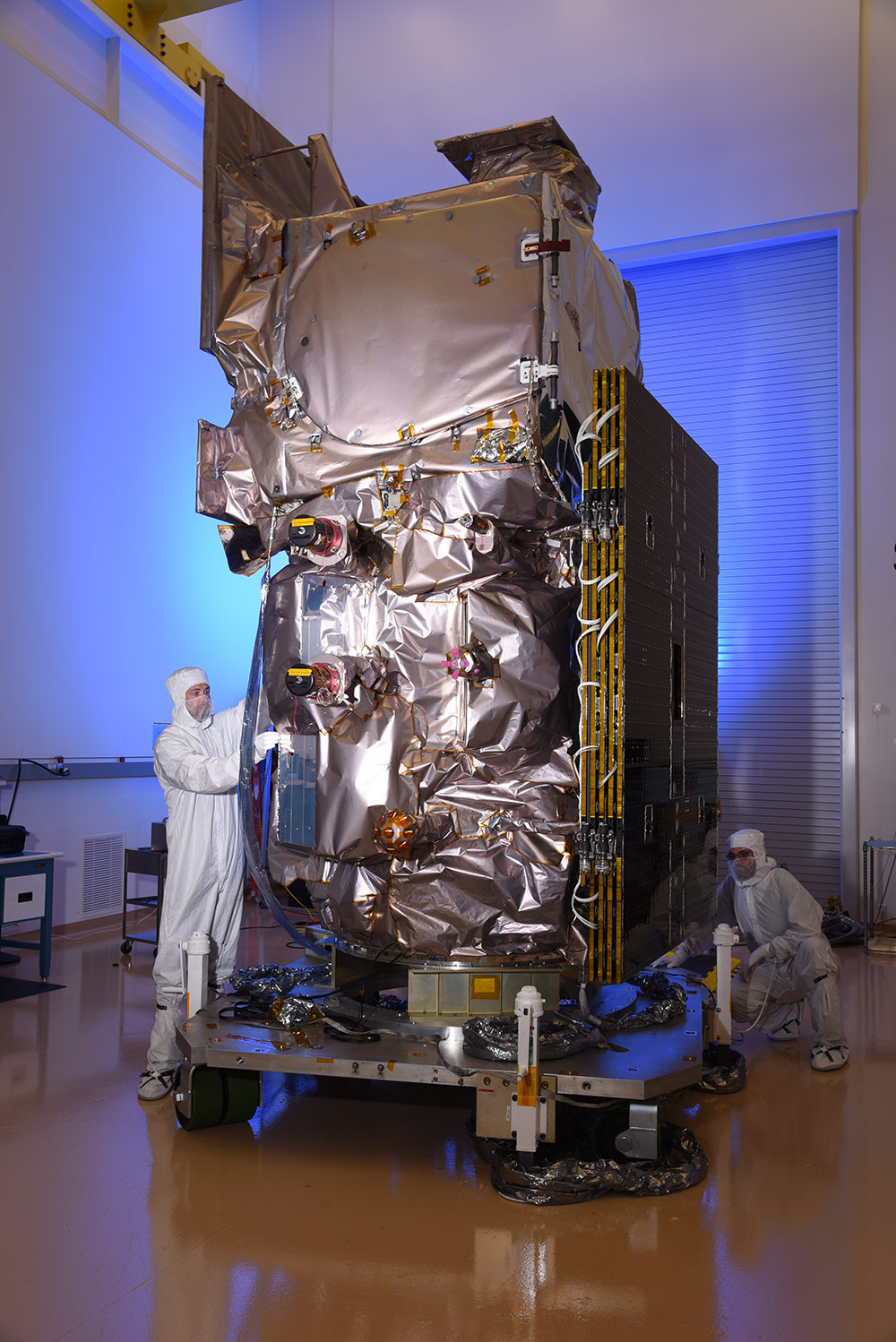 engineers building satellite in lab