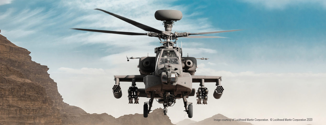 blackhawk helicopter flying over mountains