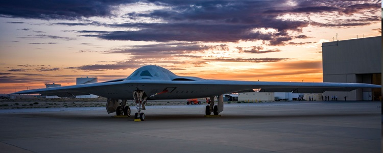 B21 on tarmac at sunset.