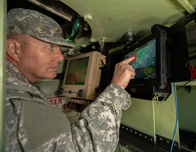 Counter Unmanned Aerial Systems (C-UAS) military man pointing to screen in vehicle