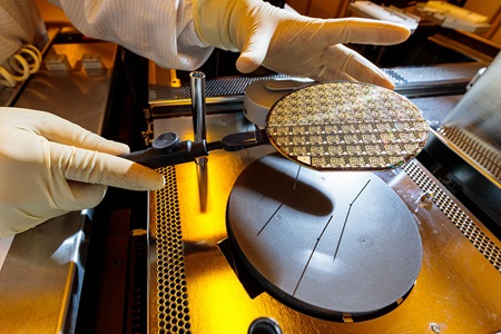 Space Park Microelectronics Foundry gloved hands handling 4-inch wafers in lab