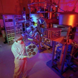 Space Park Microelectronics Foundry Lab lab technician holding microelectronics component in lab