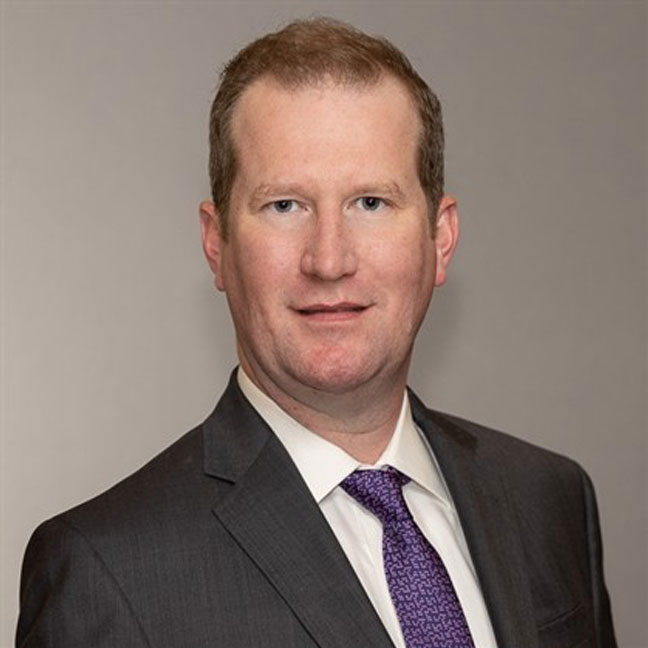headshot of man dressed in business suit