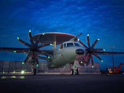 Military aircraft on tarmac with evening clouds above