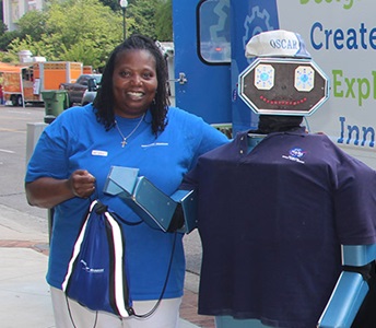 woman standing with robot.