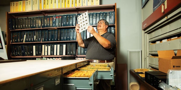 Archivist looking at media.
