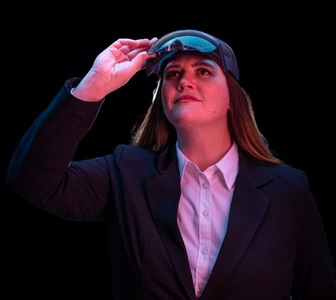 Woman looks up from virtual reality goggles.