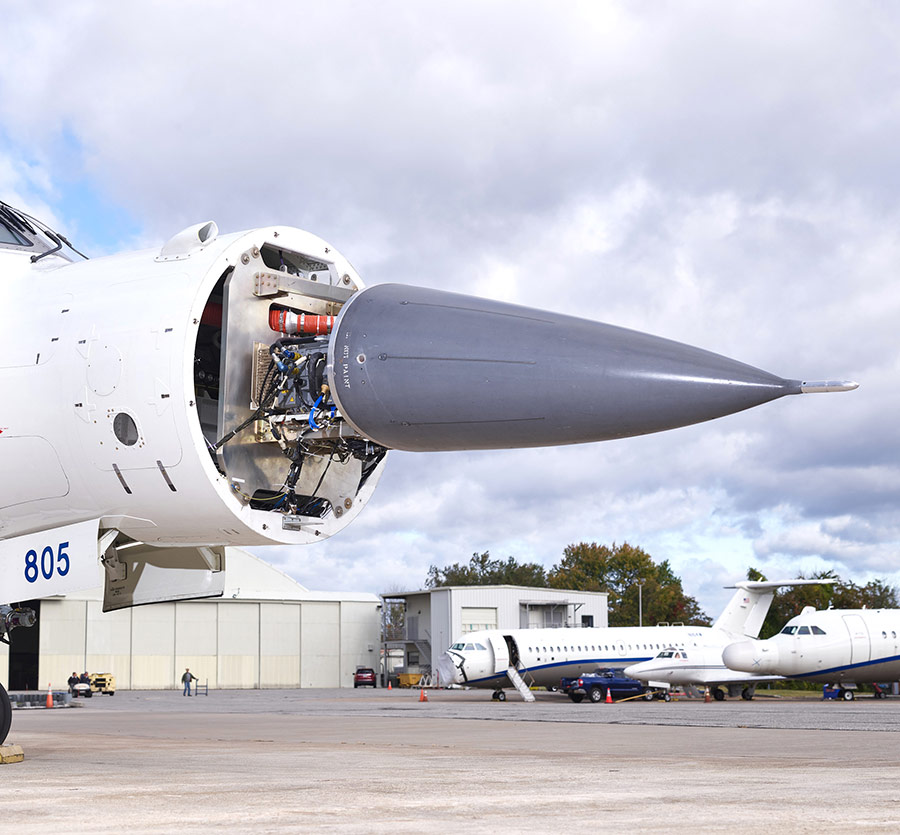 radar in nose of jet outside hanger