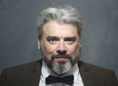 Caucasian man poses for a headshot