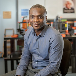 black man smiling in a lab