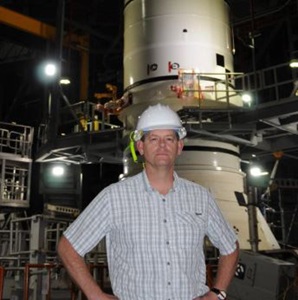 male standing in front of rocket