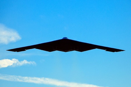 B-2 Spirit Stealth Bomber stealth flying wing over blue skies