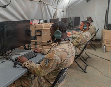 Connects-Multi-Service-Capabilities-Project-Convergence-News three US Serives members in tent working on computer network