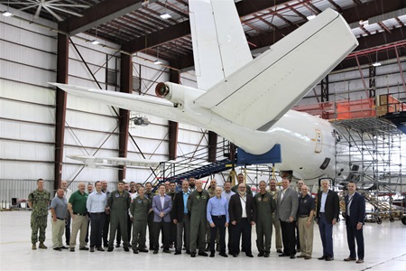 Navy Accepts Upgraded E-6B Mercury, Delivering Enhanced Capabilities to the Fleet People standing under tail of Navy E-6B Mercury aircraft