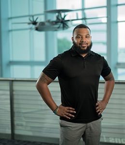 male standing in front of airplane model
