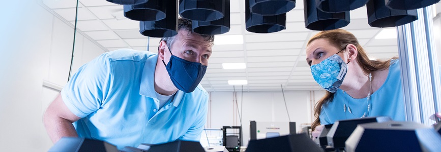 two people looking up-under photovoltaic cells