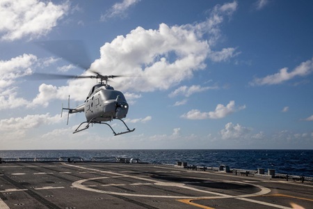 Northrop Grumman-Built MQ-8C Fire Scout Makes Operational Deployment with the US Navy A helicopter hovers above a landing pad