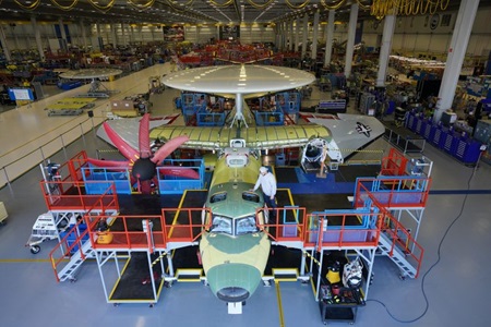 Man working on plane in factory