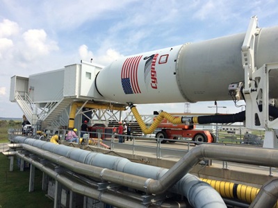 Northrop Grumman’s Antares Team Demonstrates New Capability to Load Cargo Just Before Launch Part of a rocket in a horizontal position ready for cargo to be loaded