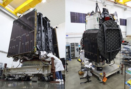 Northrop Grumman’s Second Mission Extension Vehicle and Galaxy 30 Satellite Begin Launch Preparations in French Guiana People wear lab coats in manufacturing setting preparing large parts of a spacecraft.