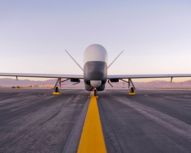 Triton – Northrop Grumman Triton aircraft on runway at sunset