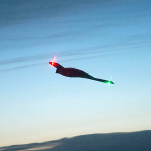 X-47B soaring in the sky at night time