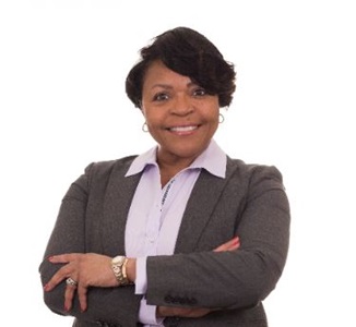 African American woman smiling with arms crossed