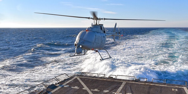 helicopter landing on back of ship in ocean