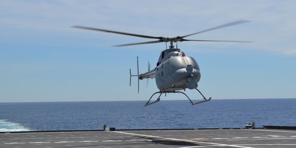 Autonomous Systems Fire Scout helicopter landing on back of ship in ocean
