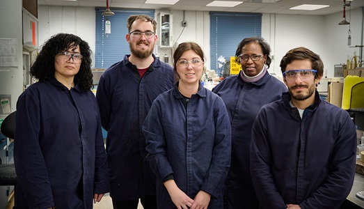 Creating the Cutting Edge – Elkton, MD five employees wearing blue coveralls