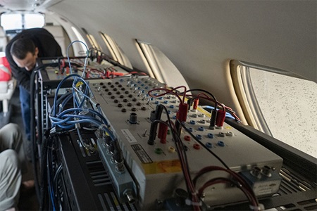 man performing pre-flight preparations aboard military plane