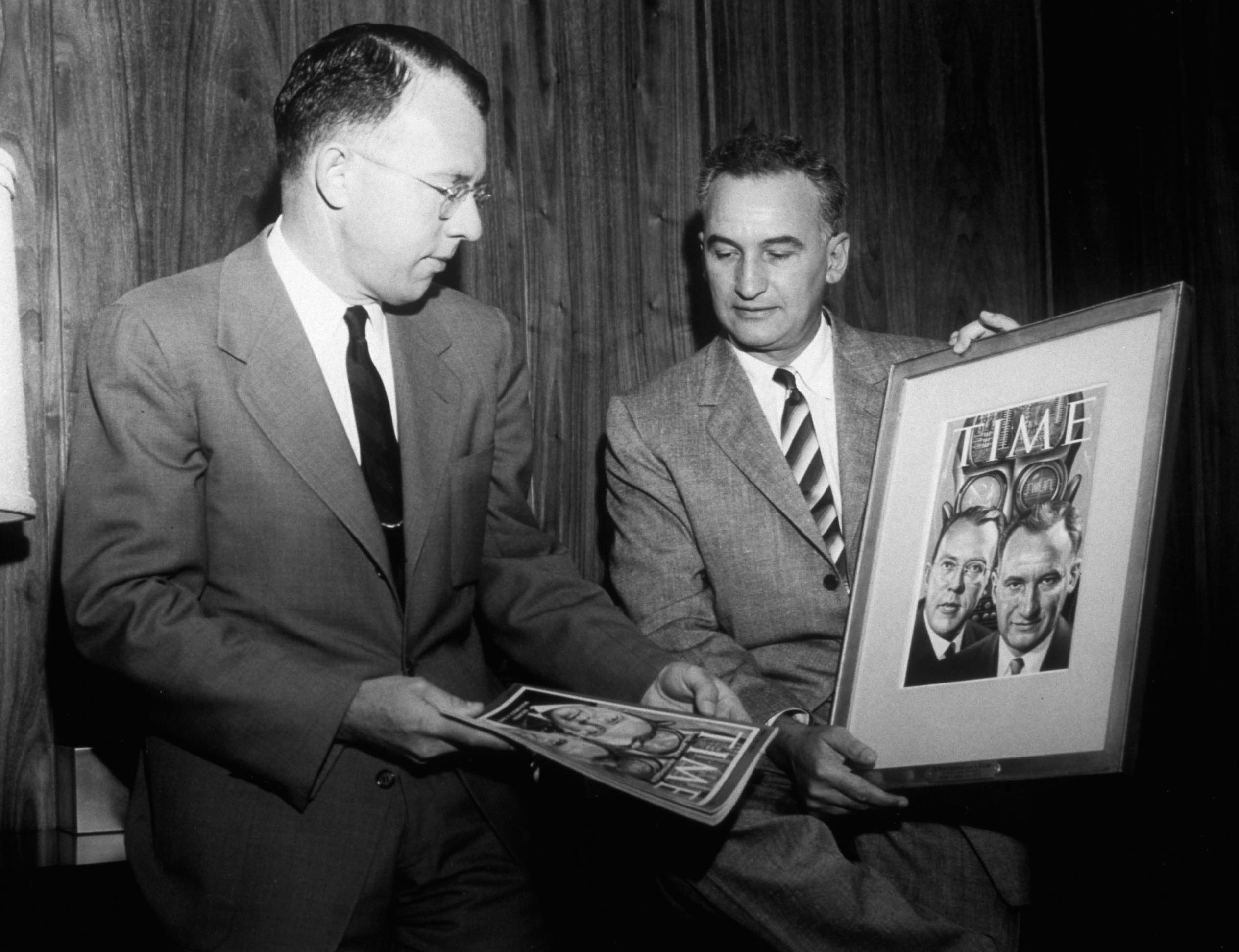 Si Ramo black and white photo with two men holding picture frame