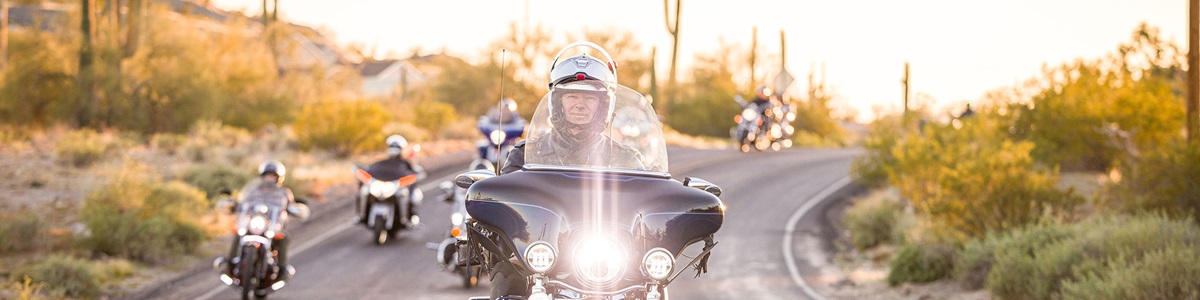 motorcyclists riding through desert