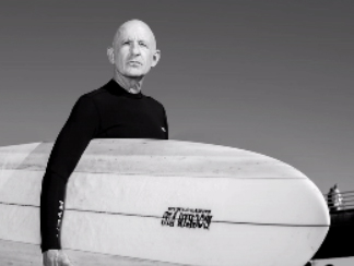 male holding surfboard