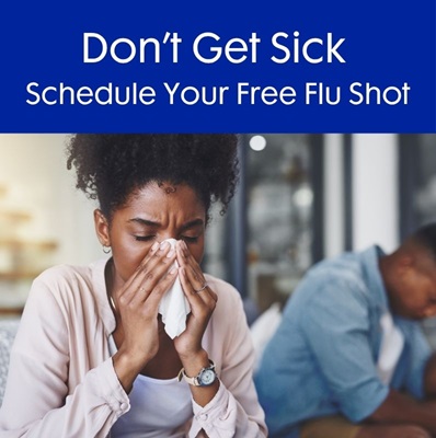 Woman blowing nose - appears to have the flu