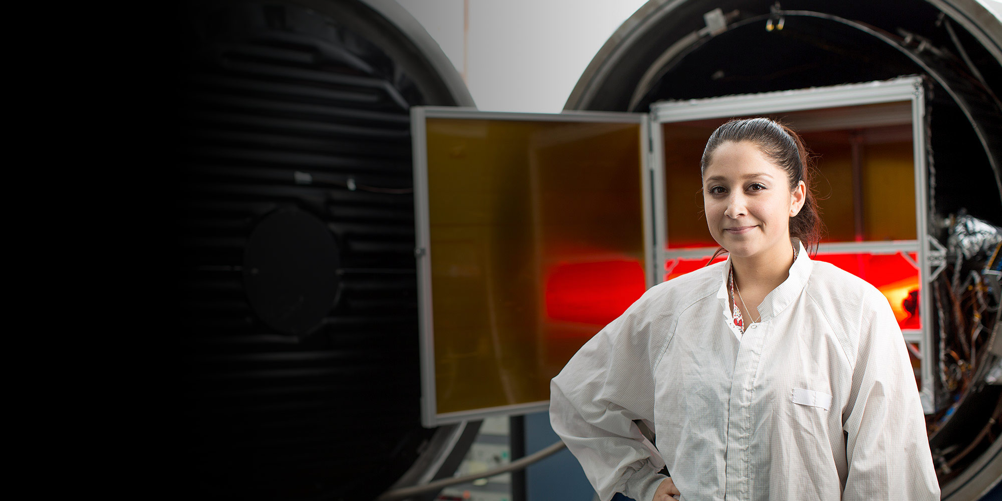 woman in clean suit in laboratory machinery