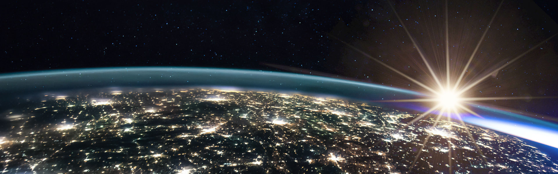 [12:48 PM] Mroz, Caroline C [US] (CO) Alt text: Sun rises over planet Earth, with city lights visible from space.