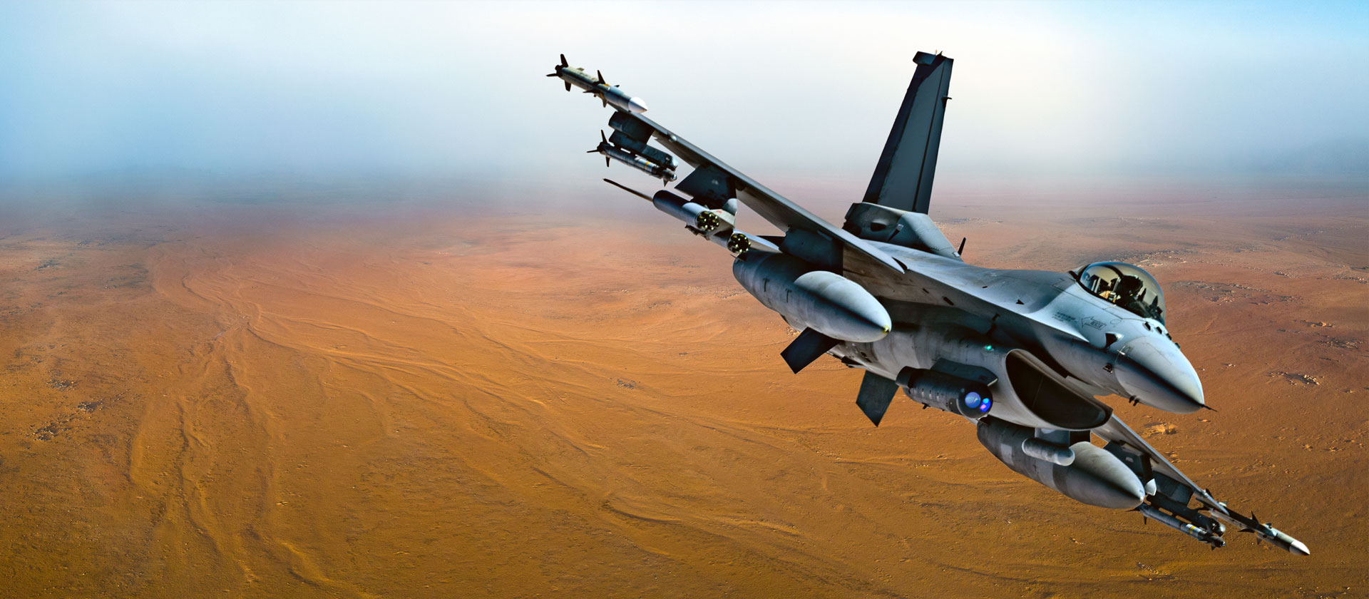 military jet flying over desert