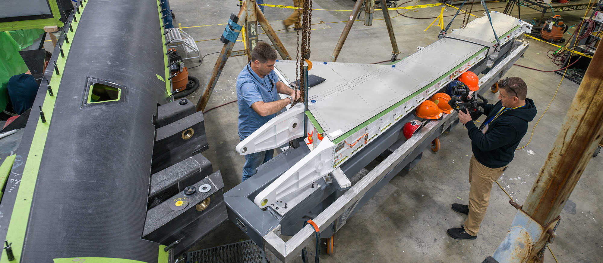 men working on aircraft wing