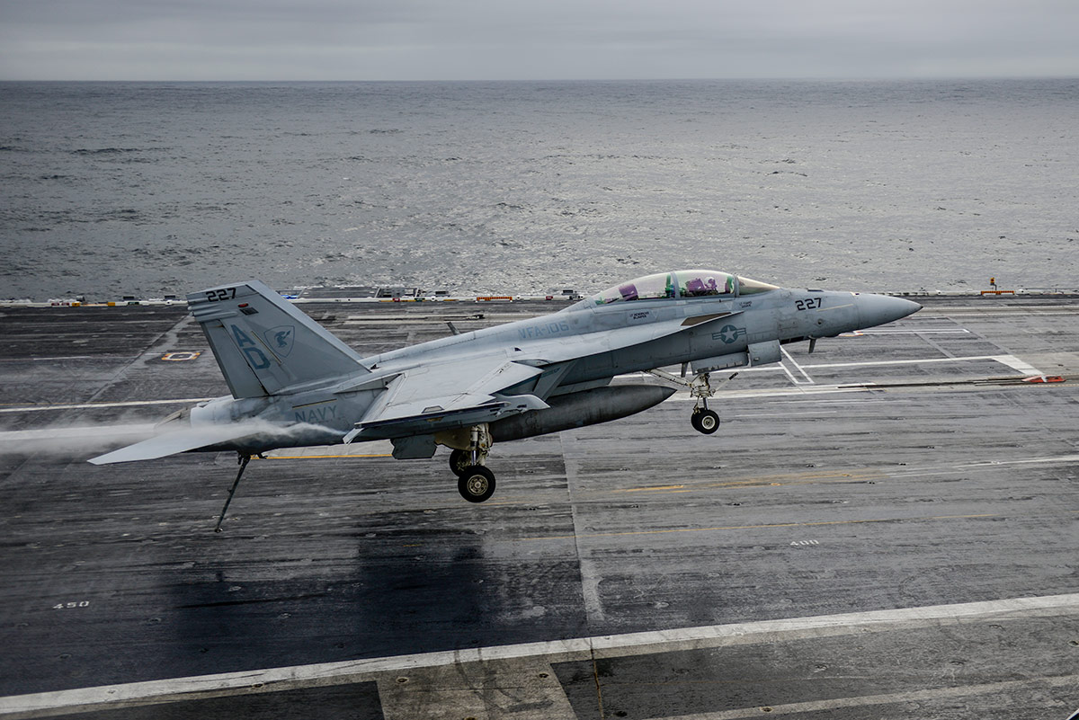 Military aircraft taking off on carrier deck