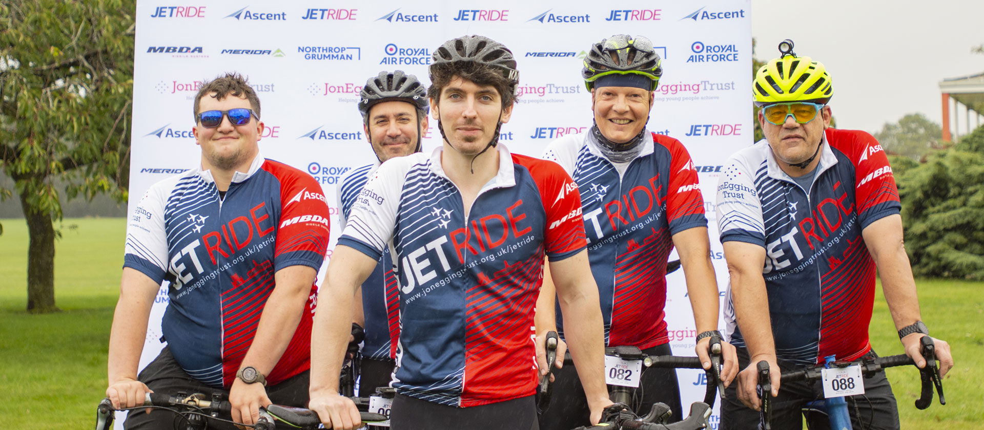 Image of company bike team wearing cycling uniform and posing with bikes. 