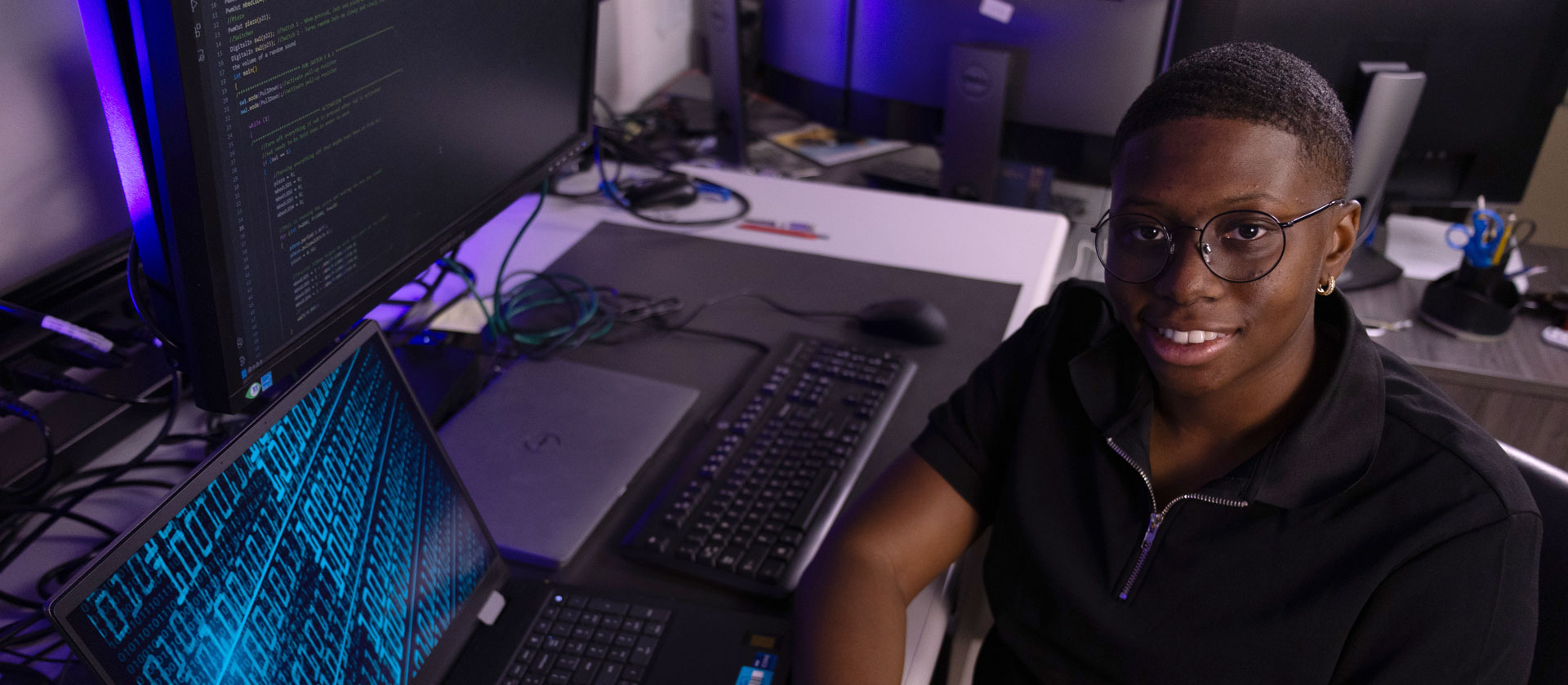 Woman sits at desk with computer